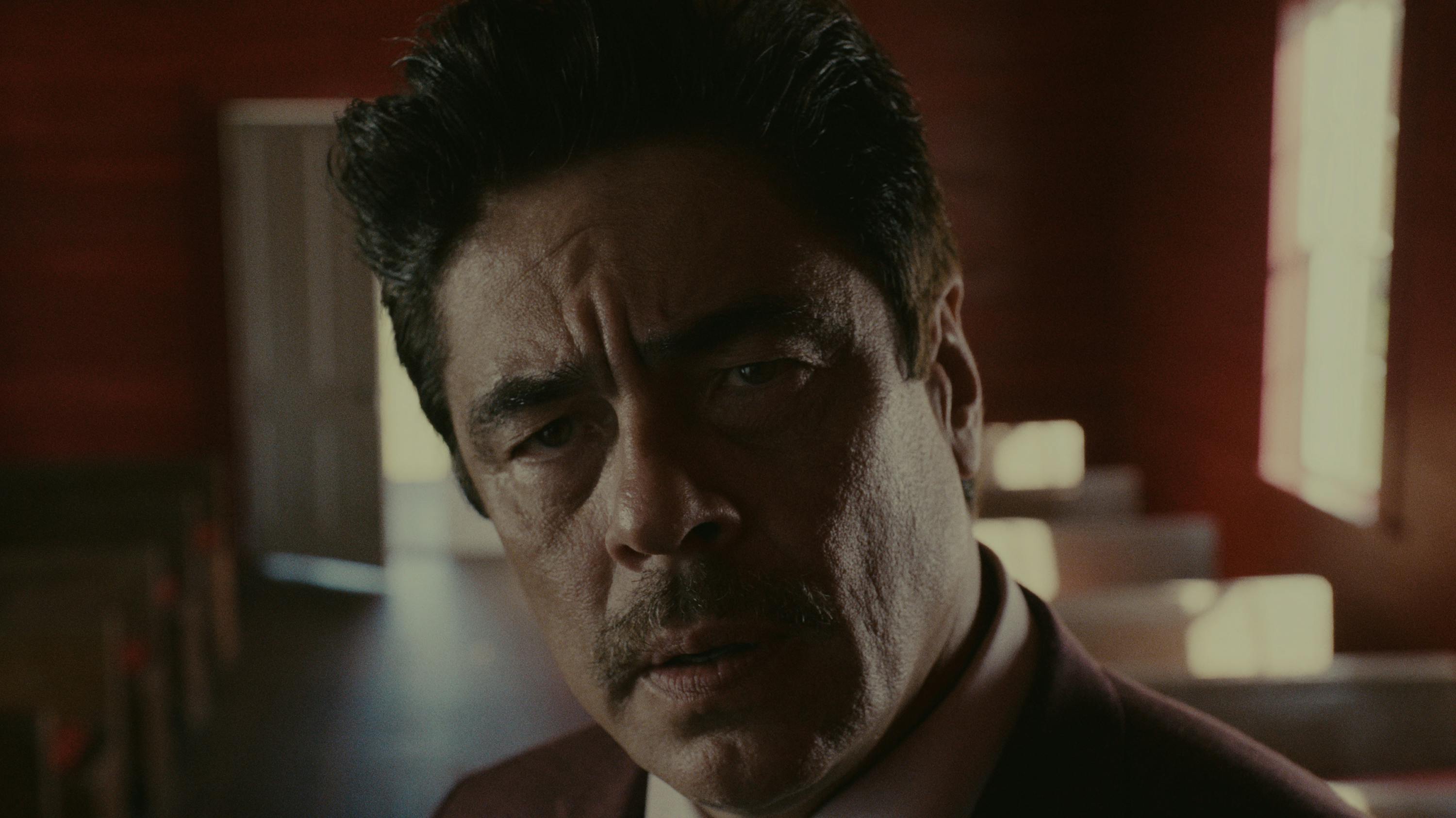 Tom Nichols (Benicio del Toro) looks perturbed in this close-up shot.