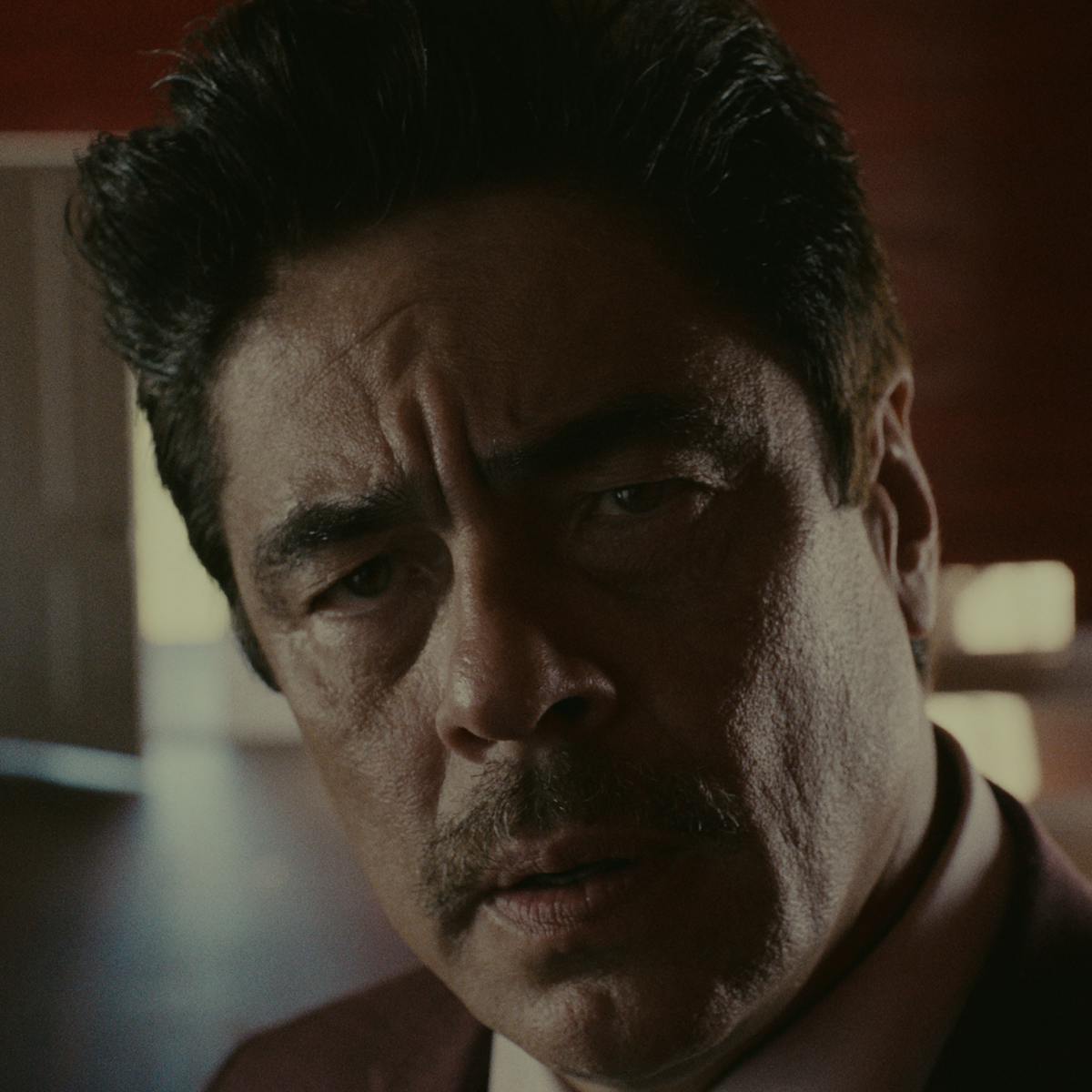 Tom Nichols (Benicio del Toro) looks perturbed in this close-up shot.