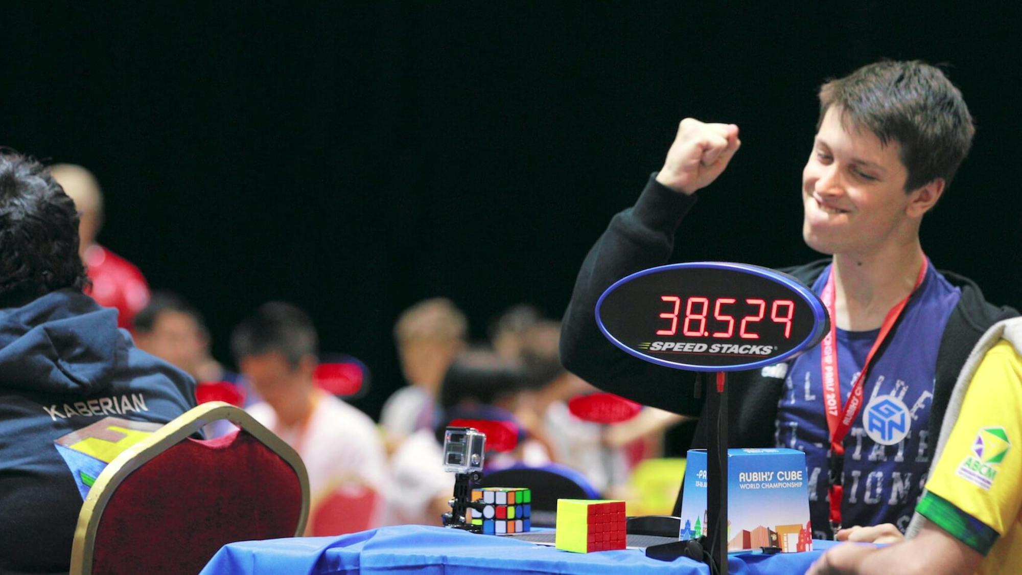Feliks Zemdegs raises his fist after completing a difficult Rubik’s cube solve. The timer reads: 38.529.
