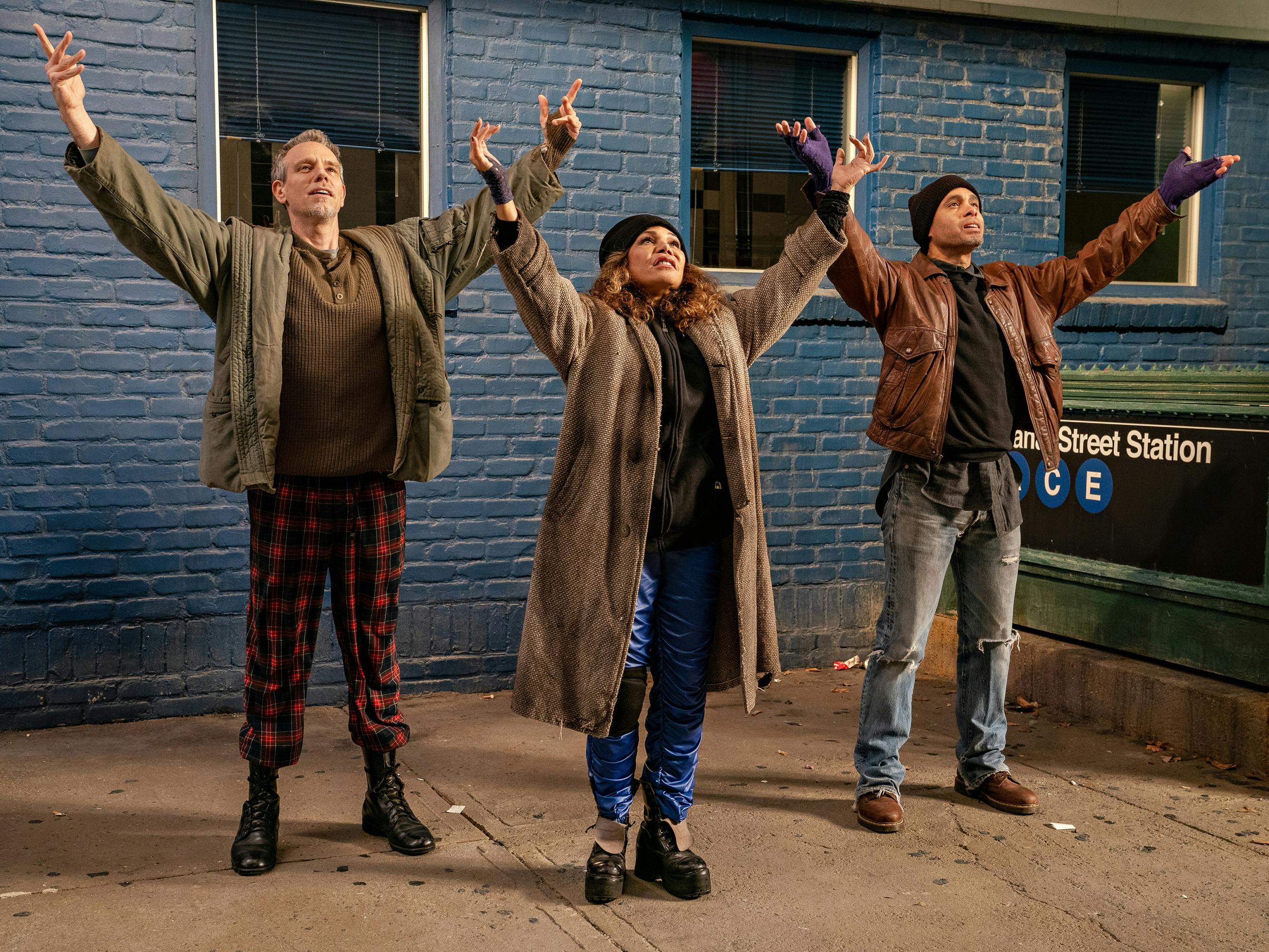 Adam Pascal, Daphne Rubin-Vega, and Wilson Jermaine Heredia stand outside the Canal street subway stop wearing fabulous 90s grunge.