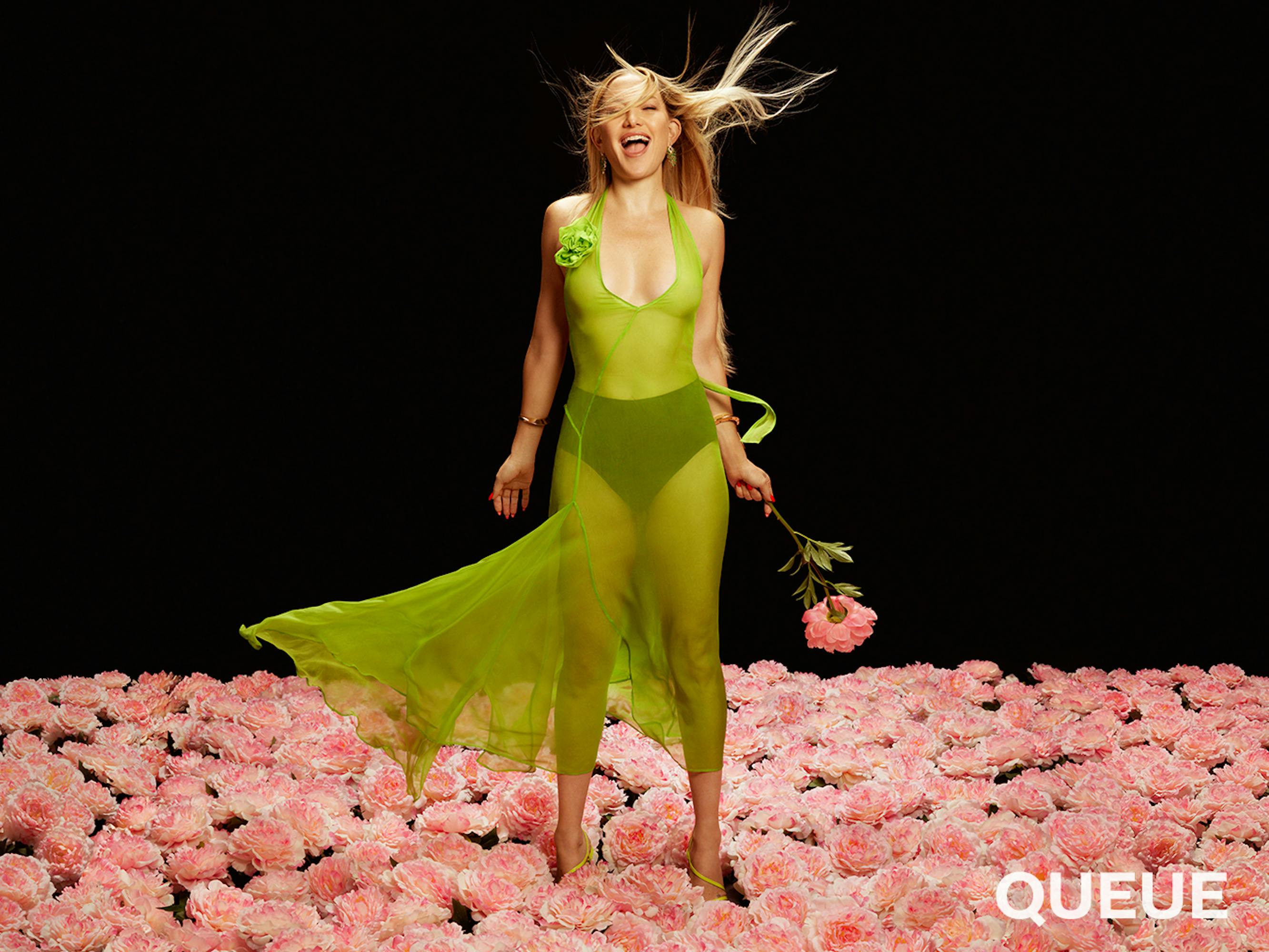 Kate Hudson wears a sheer lime green dress over black underwear and stands in a field of roses on this digital cover.