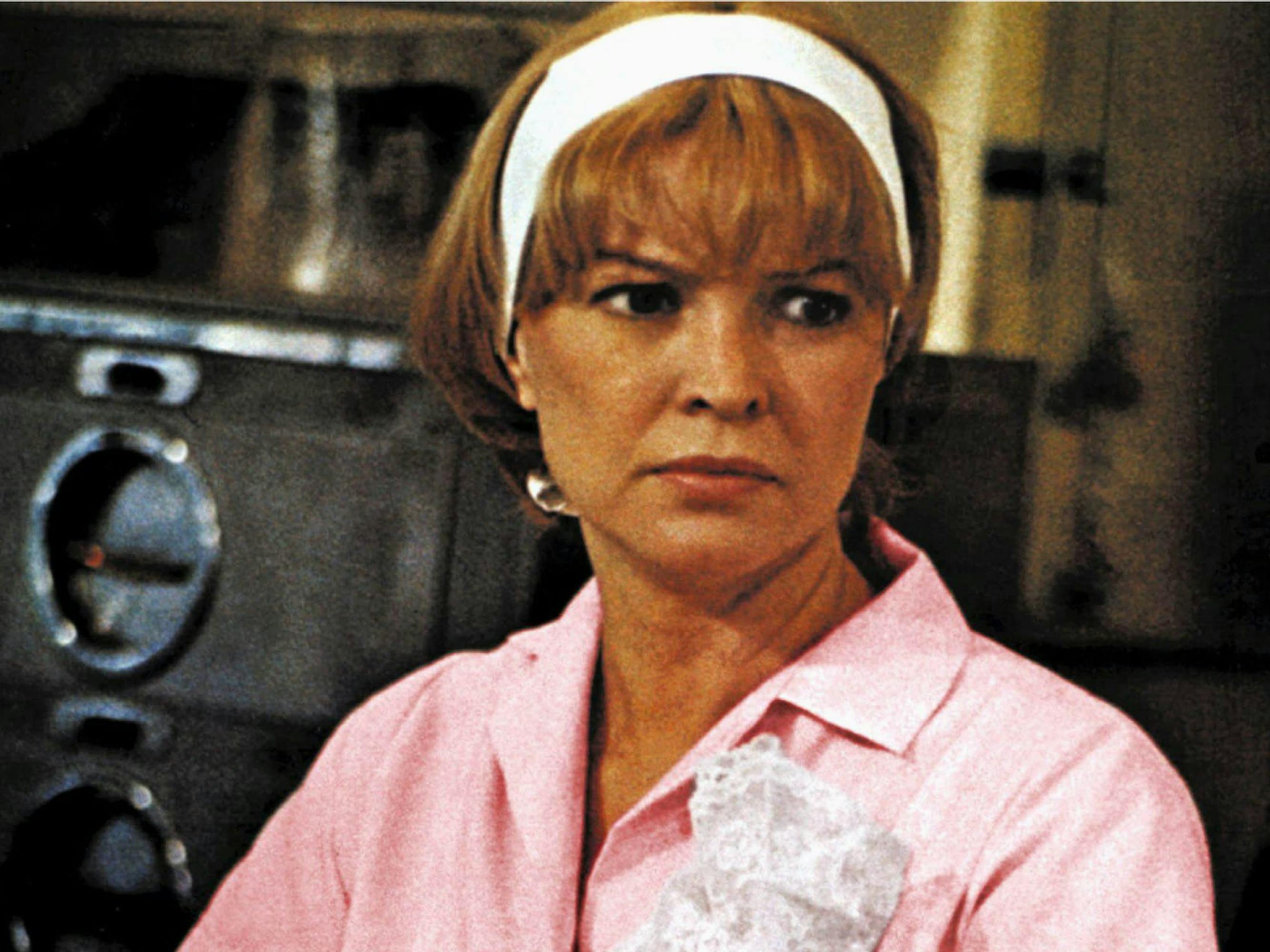 Ellen Burstyn as Alice Hyatt in a still from Alice Doesn’t Live Here Anymore. She wears a Pepto-Bismol pink waitress’s uniform and a thick white headband.