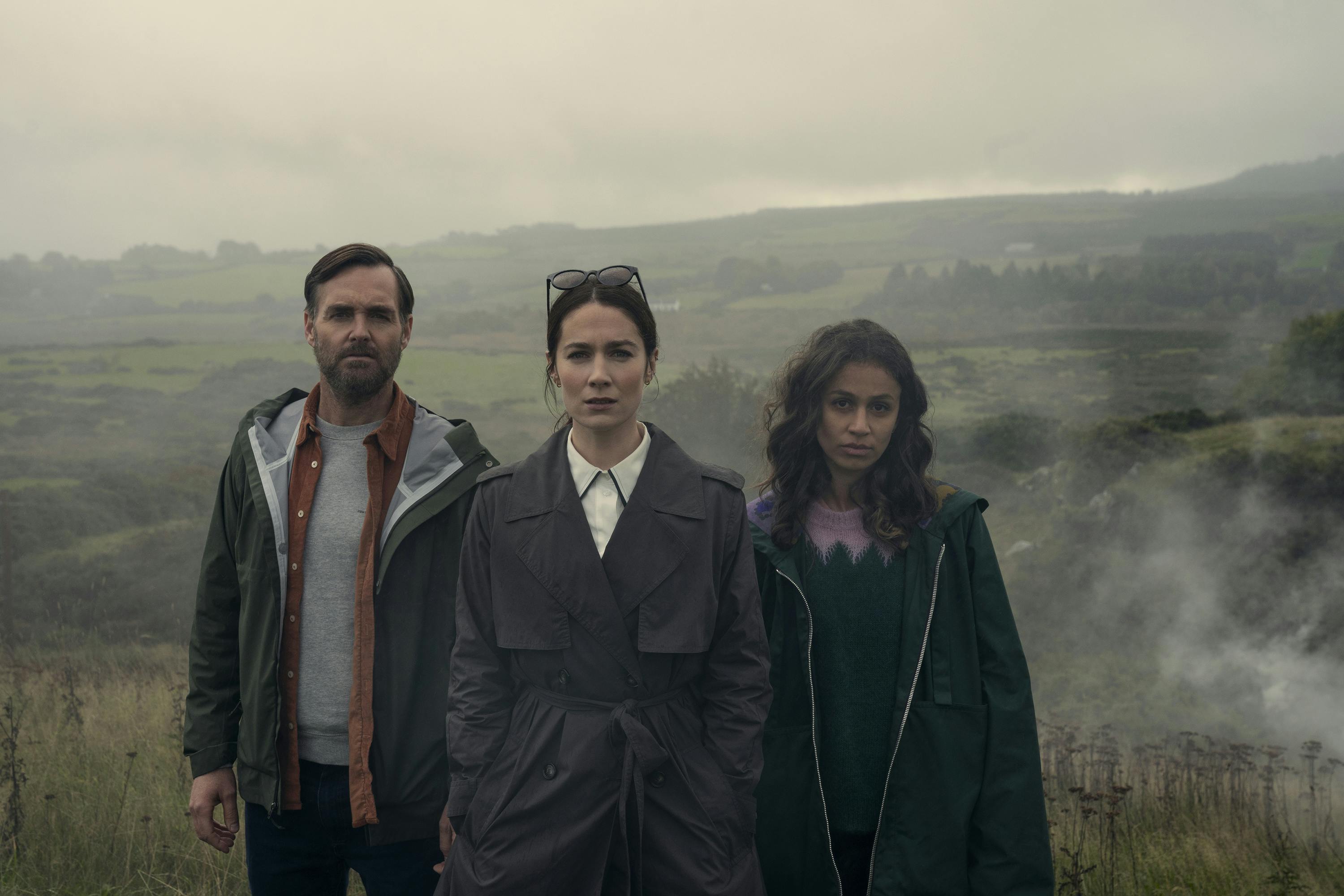 Gilbert (Will Forte), Dove (Siobhán Cullen), and Emmy (Robyn Cara) stand in a foggy field.