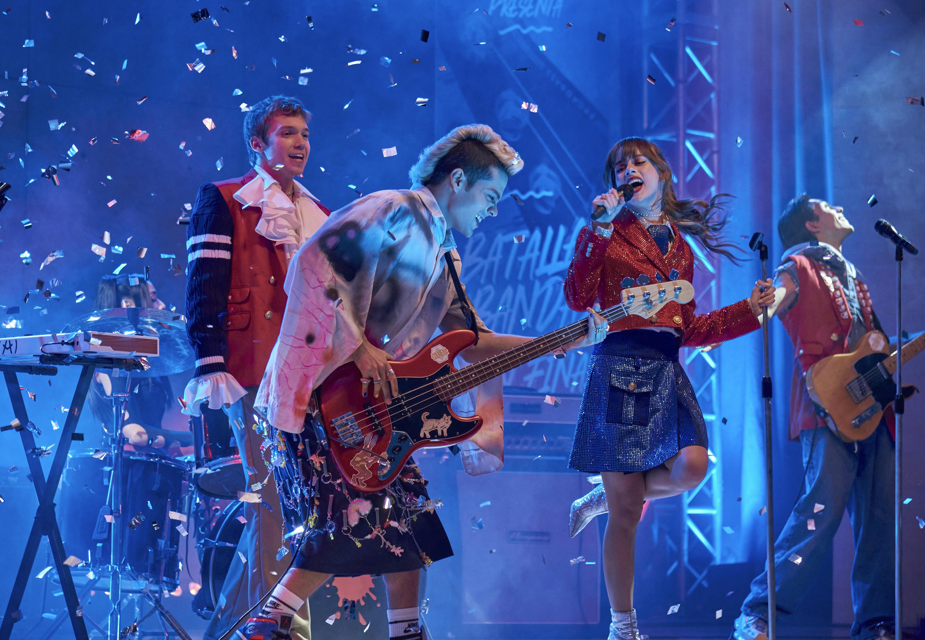 The cast of Rebelde rock out on a confetti strewn stage.