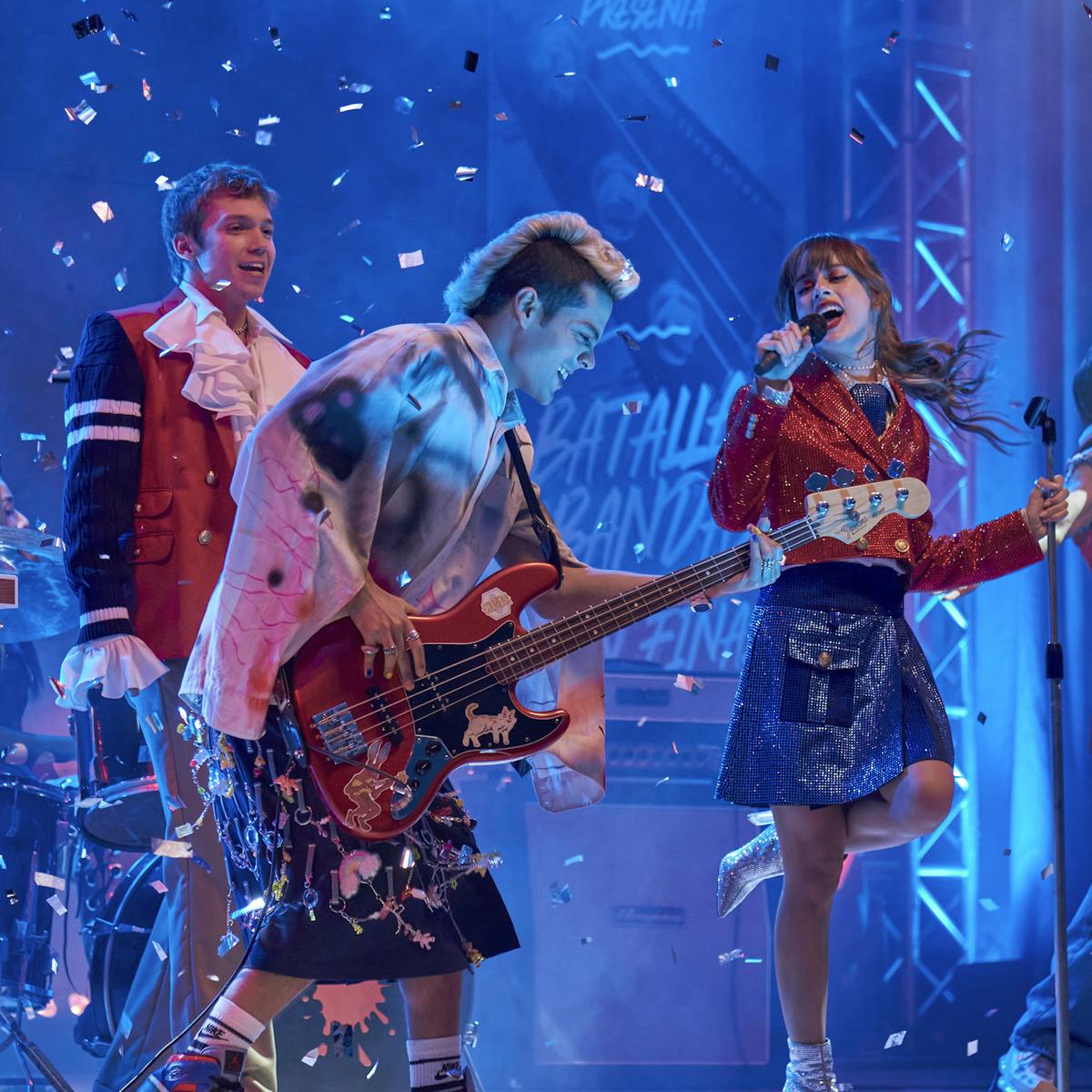 The cast of Rebelde rock out on a confetti strewn stage.
