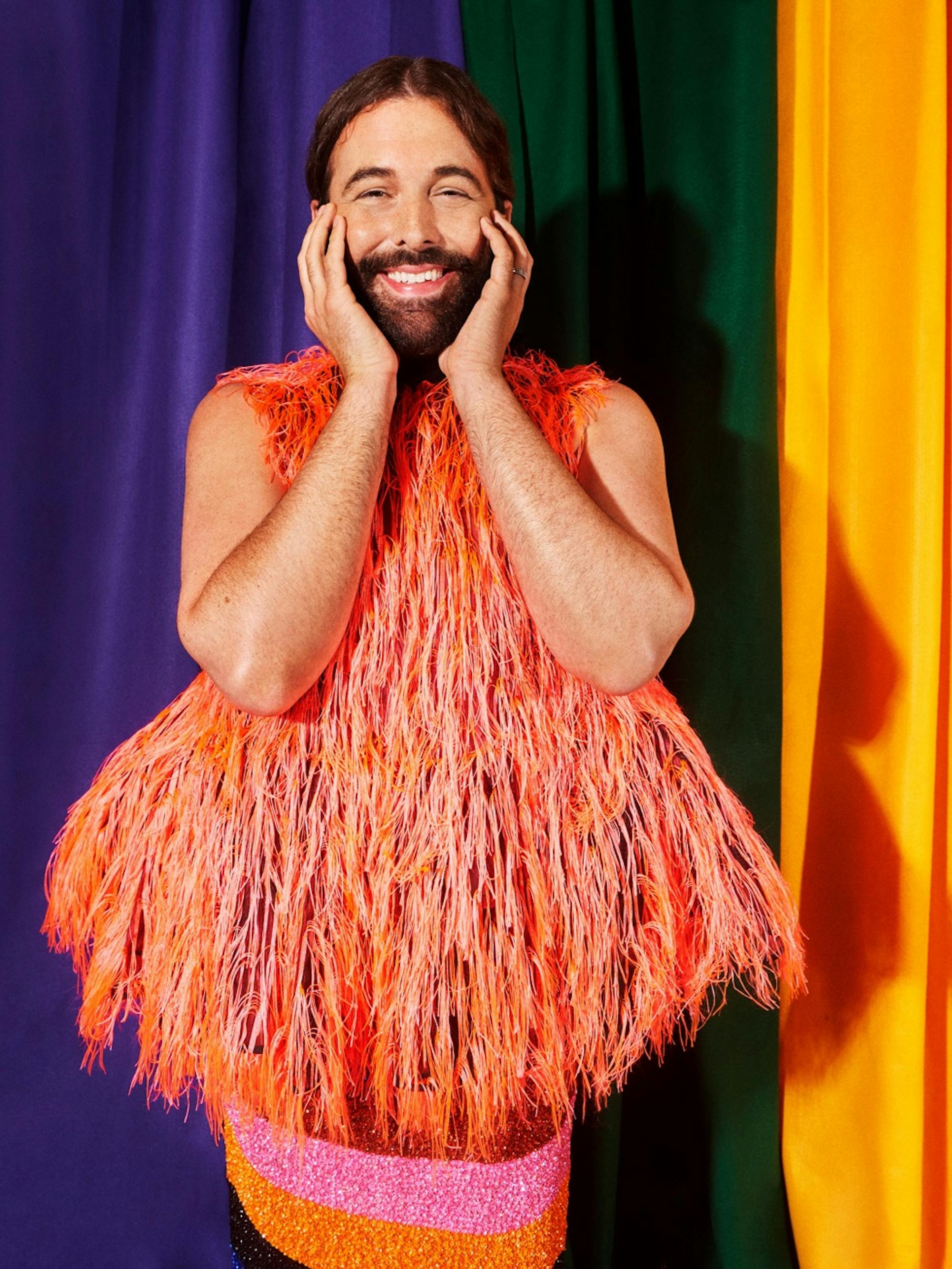 Jonathan Van Ness wears a orange furry top