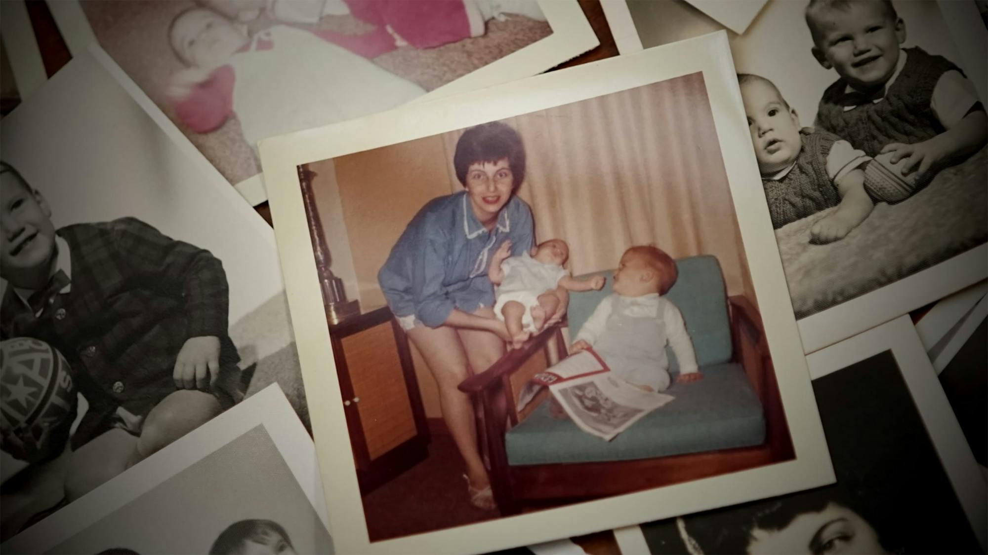 A spread of faded polaroids. In the center is a picture of a young Kulik holding a baby, while another child looks up at the two. 