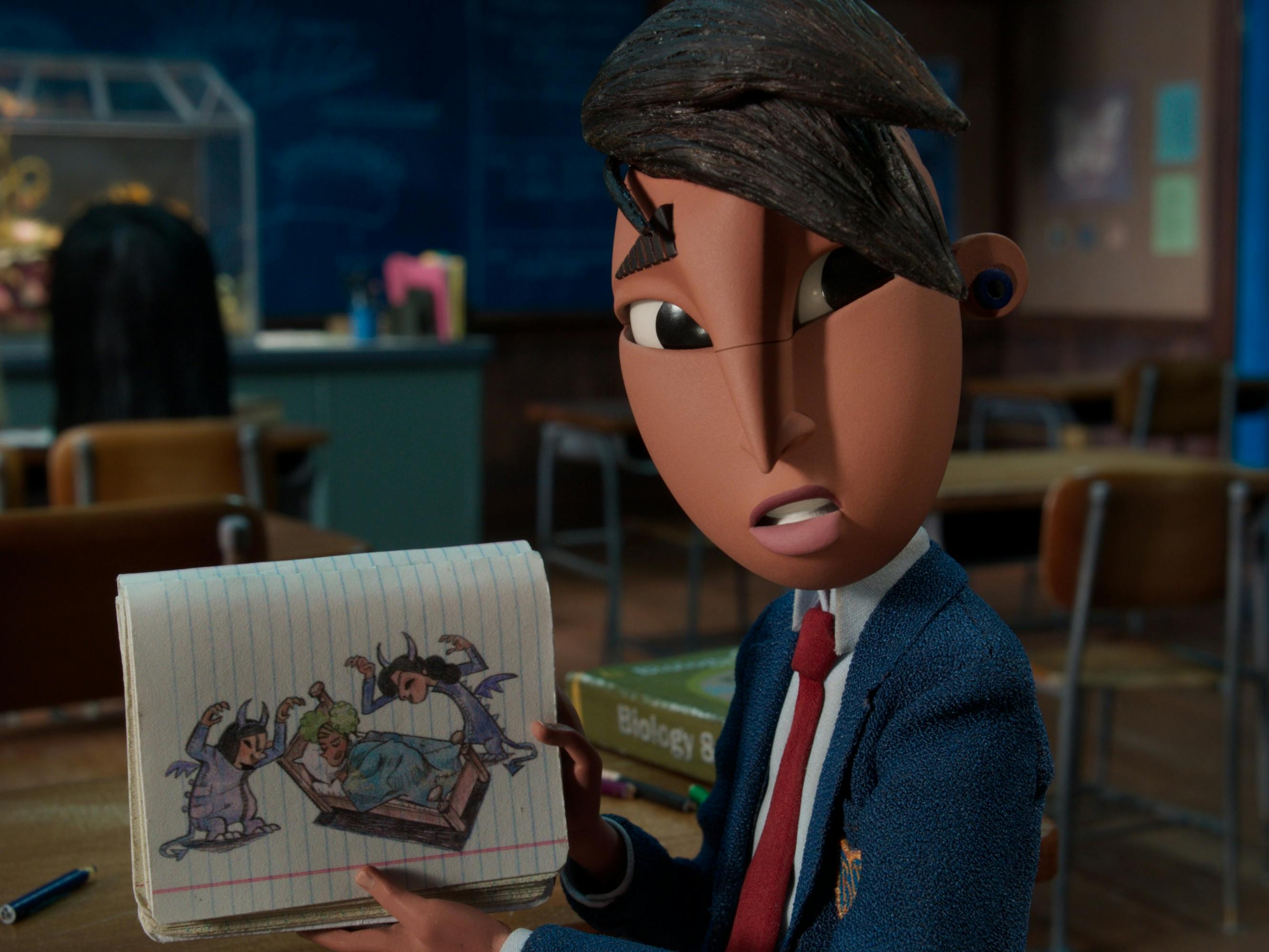 Raúl (Sam Zelaya) shows a drawing of two figures hovering over a blue-blanketed bed.