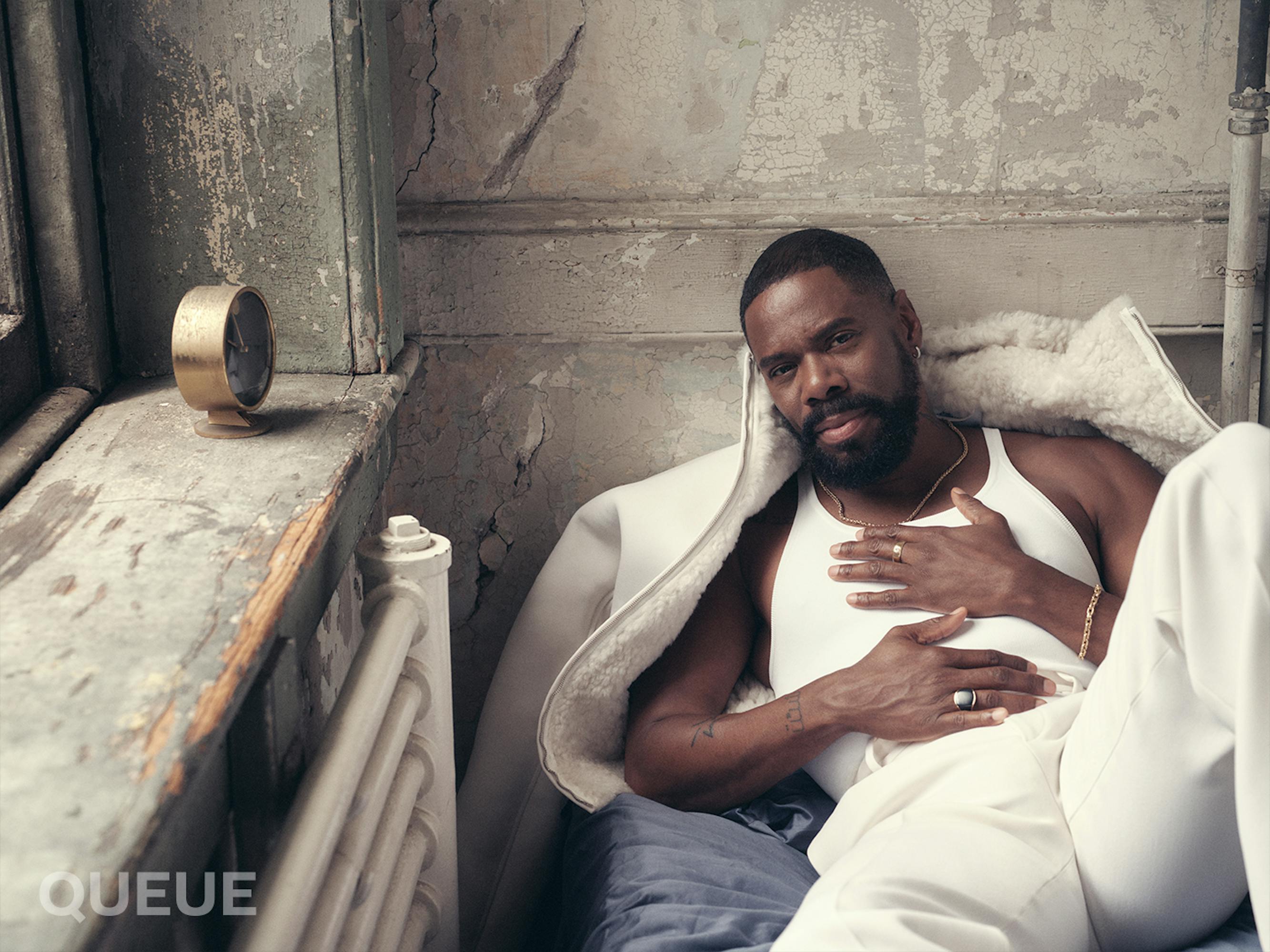 Colman Domingo wears a white tank tank top, white pants, and a white jacket.