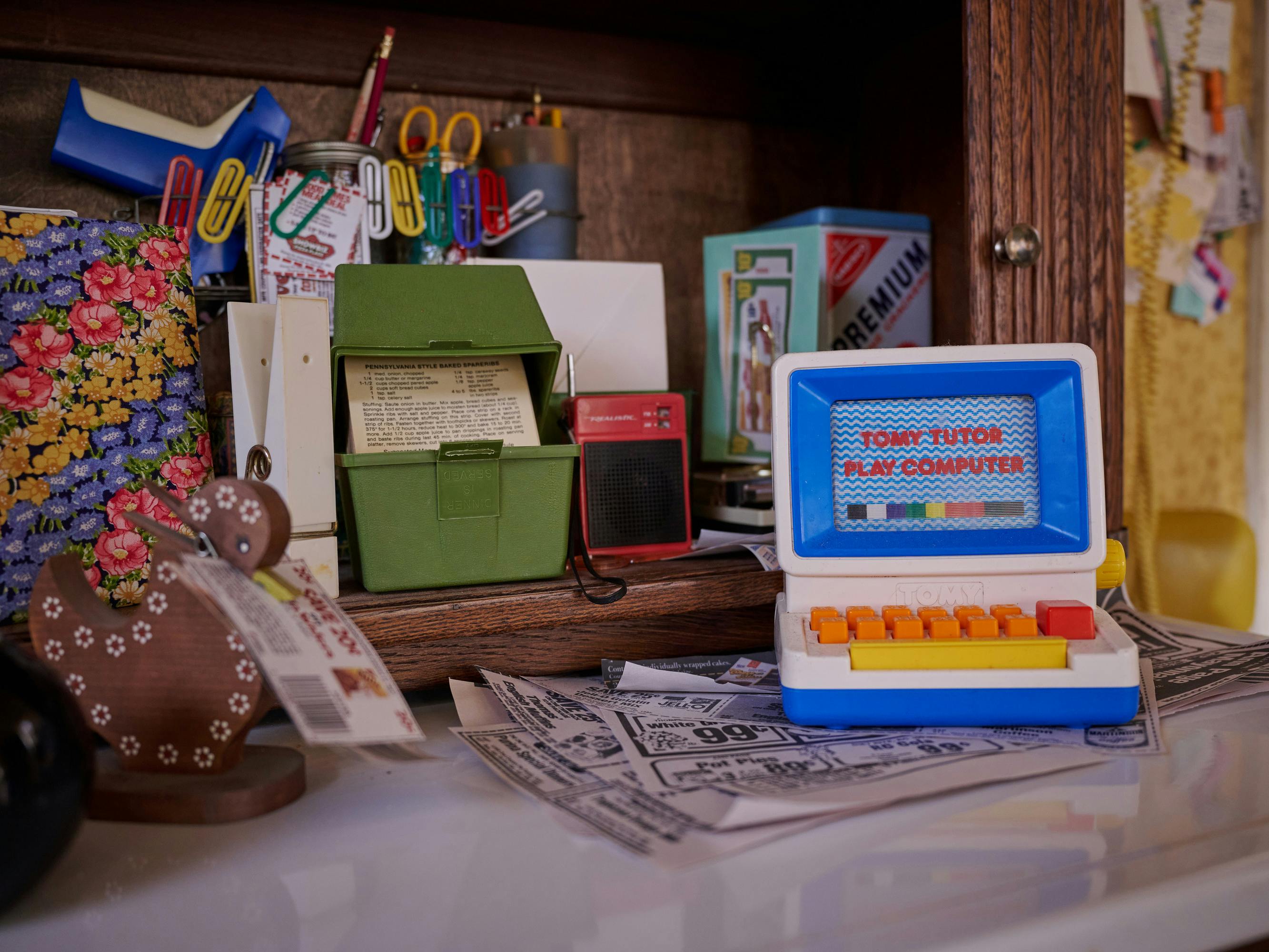 A view of the Gladney kitchen nook, bursting at the seams with recipe cards, coupons, miscellaneous office supplies and a toy computer.