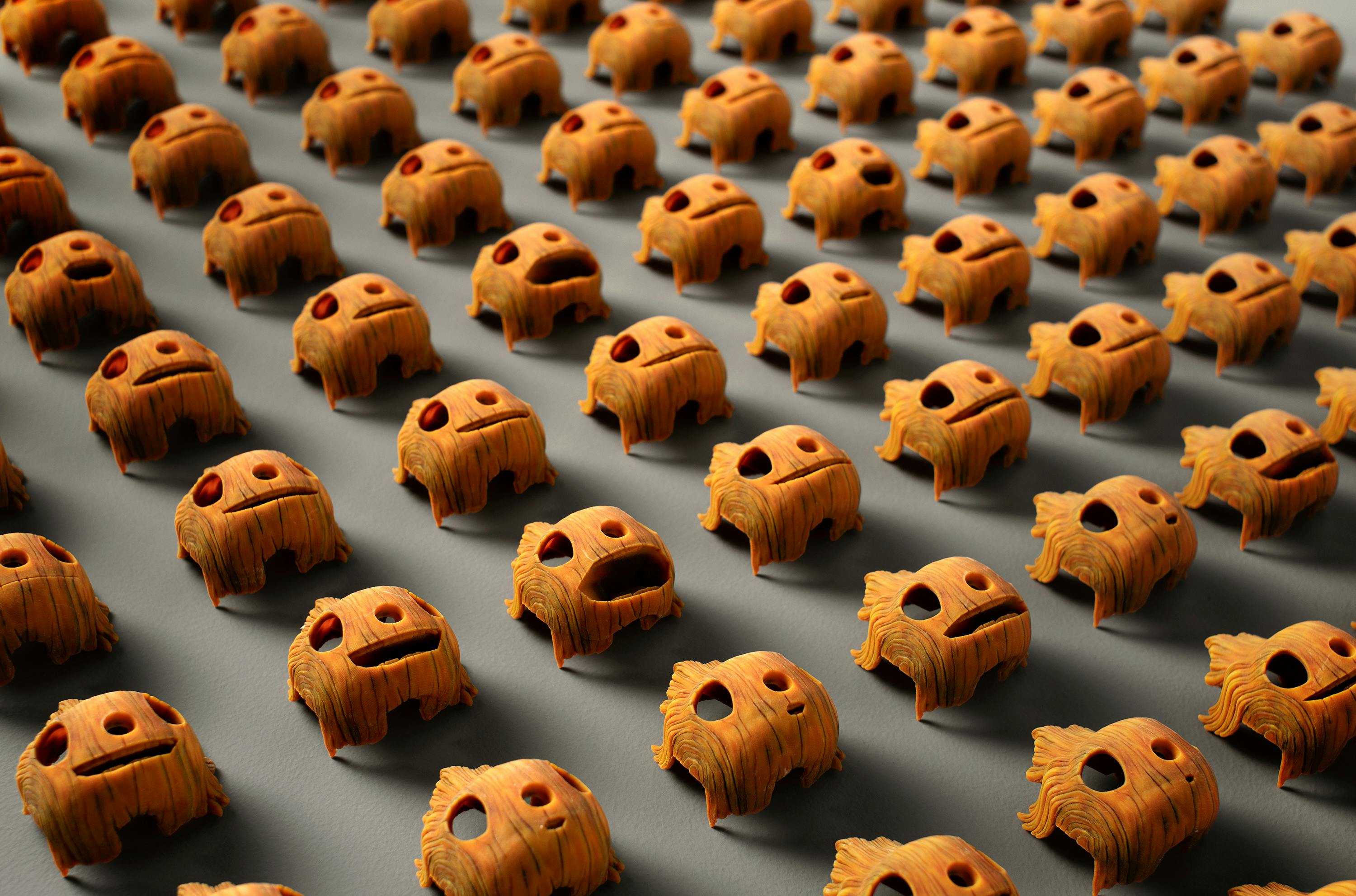 A grid of Pinocchio's many wooden faces, in a myriad of expressions.