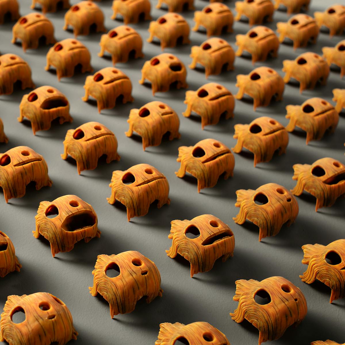 A grid of Pinocchio's many wooden faces, in a myriad of expressions.