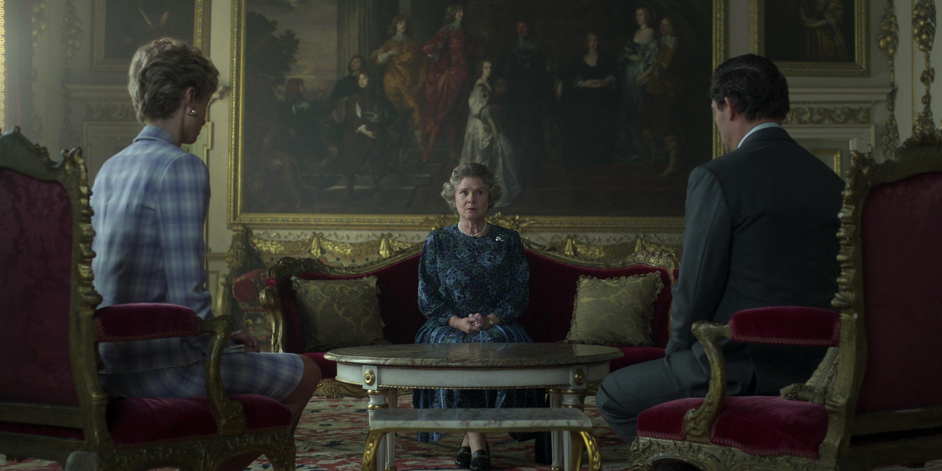 Princess Diana (Elizabeth Debicki), Queen Elizabeth (Imelda Staunton), and Prince Charles (Dominic West) sit around looking uncomfortable and tense.