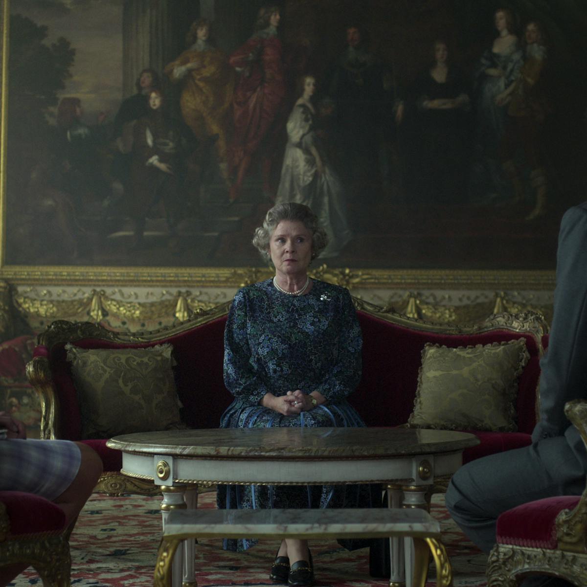 Princess Diana (Elizabeth Debicki), Queen Elizabeth (Imelda Staunton), and Prince Charles (Dominic West) sit around looking uncomfortable and tense.