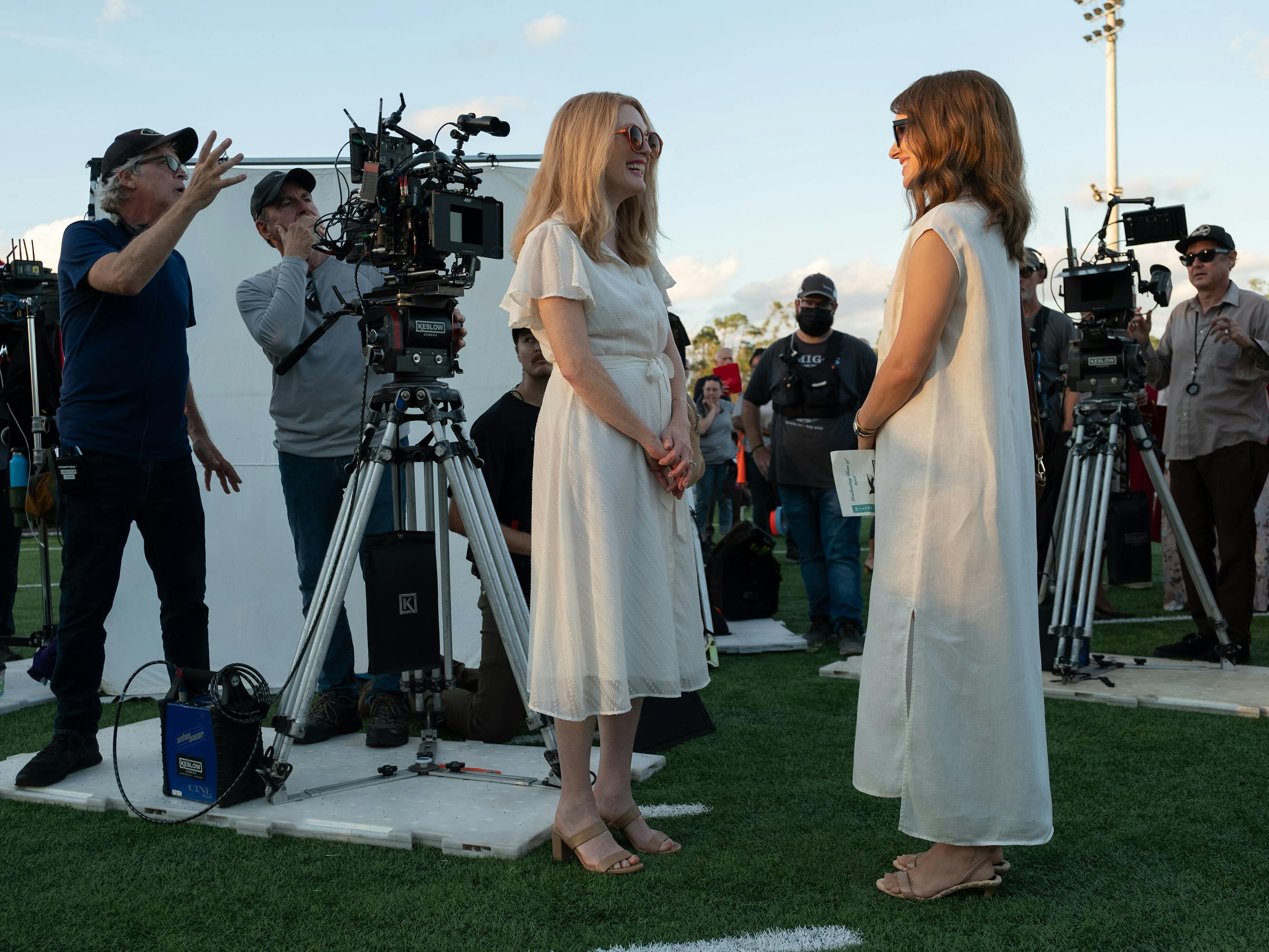 Todd Haynes, Julianne Moore, and Natalie Portman on set. Both women wear long white dresses and look quietly terrifying.