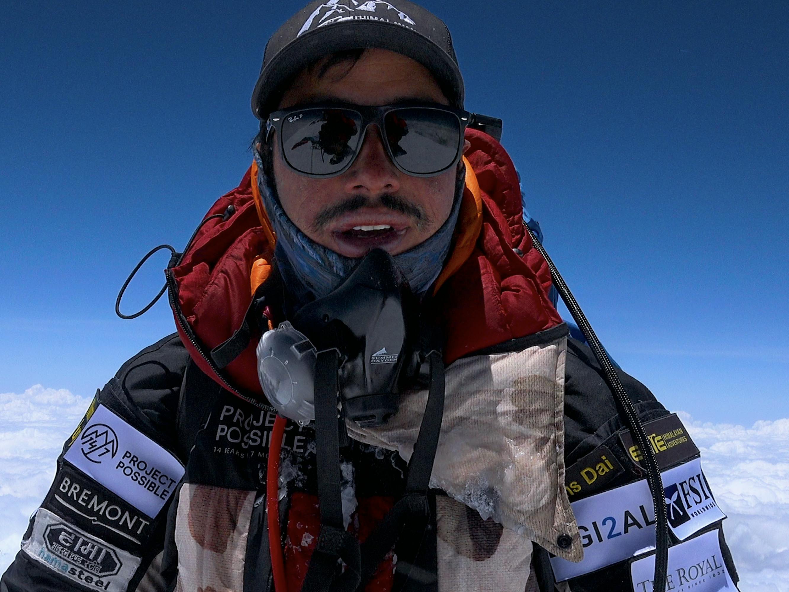 Nims Purja wears a fullbody parka, glasses, and a hat and still looks frosty.