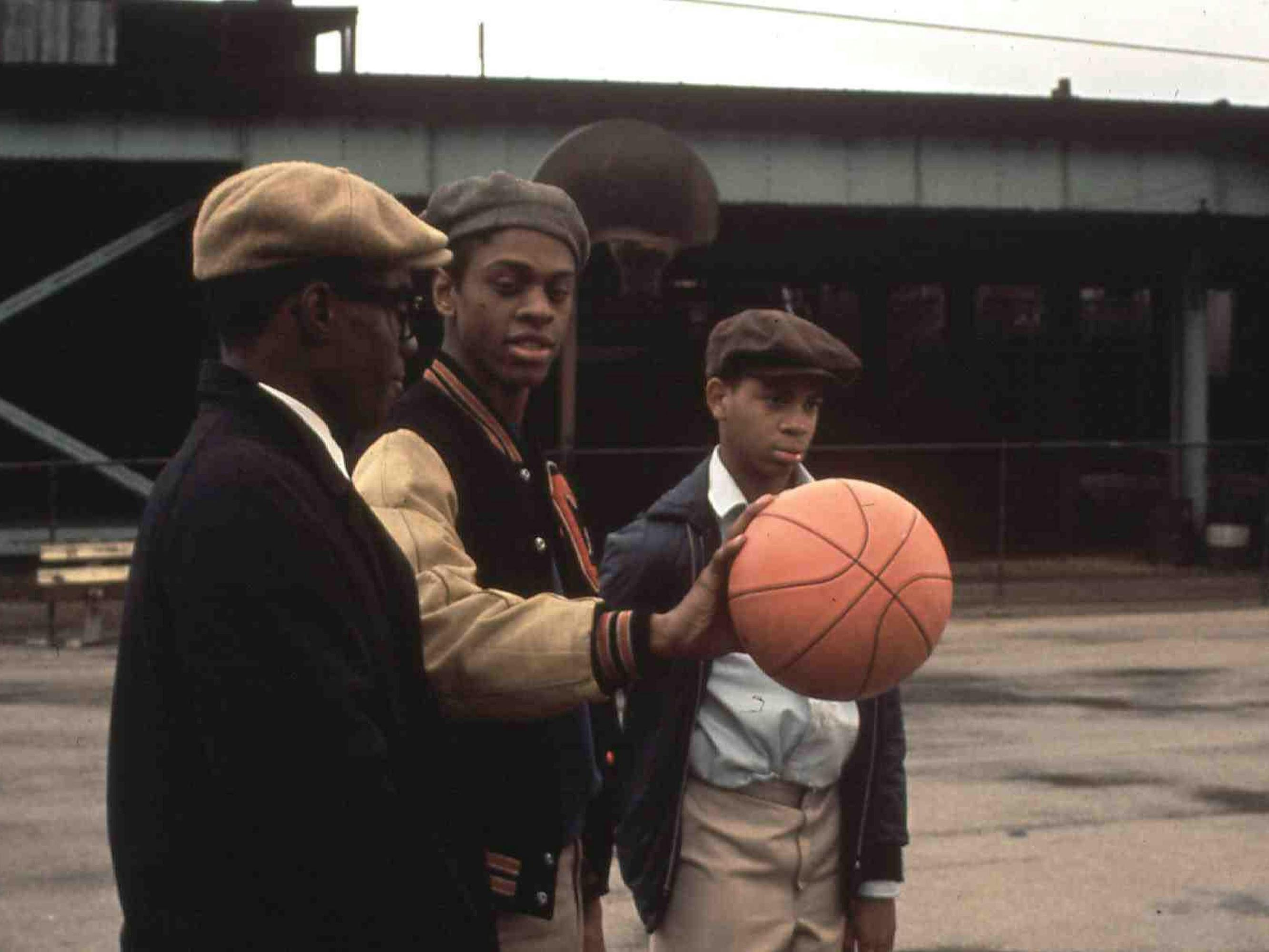 Preach (Glynn Turman), Cochise (Lawrence-Hilton Jacobs), and Pooter (Corin Rogers) hang out on a basketball court. 