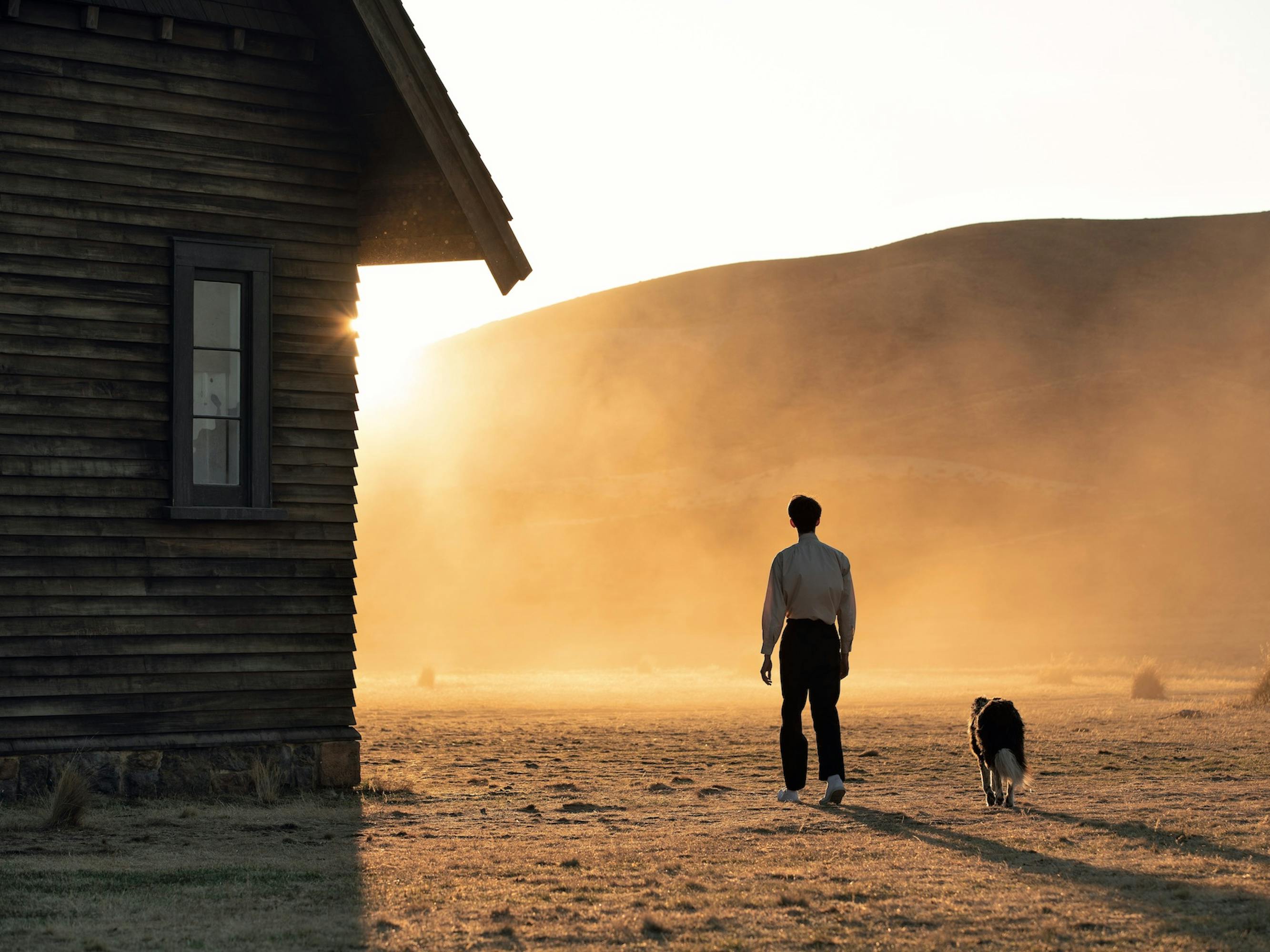 Peter Gordon (Kodi Smit-McPhee) and a dog walk into the dust sun.