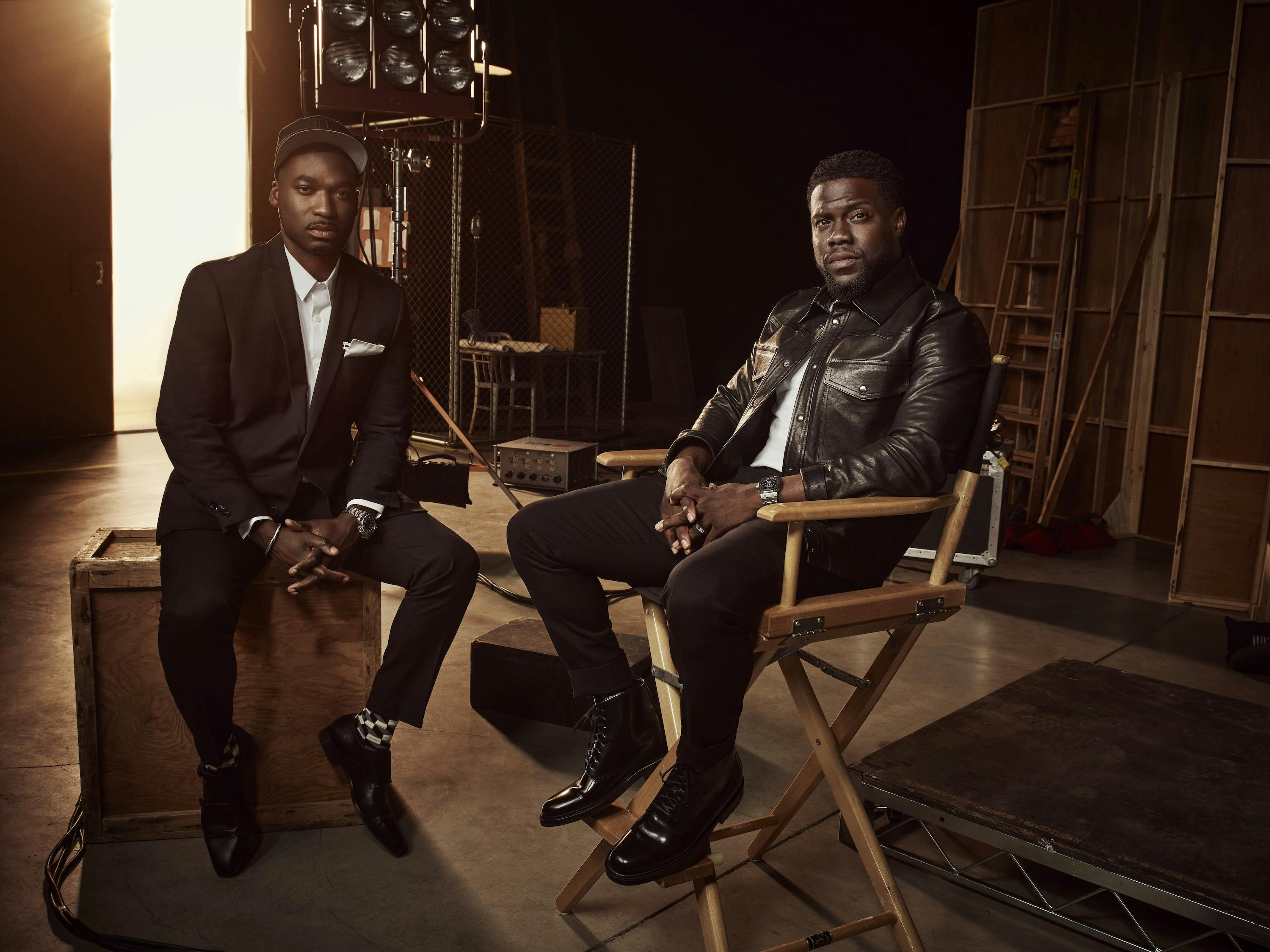 Bryan Smiley and Kevin Hart look dramatic sitting in directors chairs in a this chic sunlit shot.