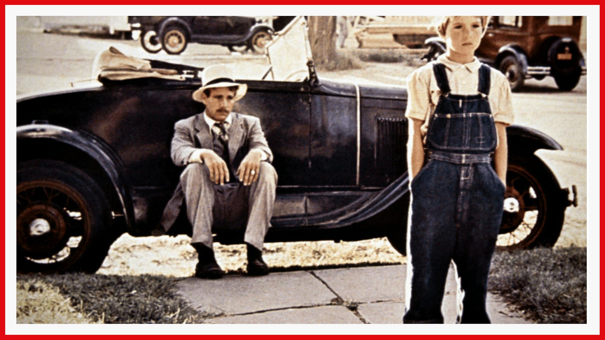 The O’Neals look dejected as Moses and Addie, a con man and his unlikely young friend. Ryan is slouched on his car while Tatum stands with hands in her overall pockets.