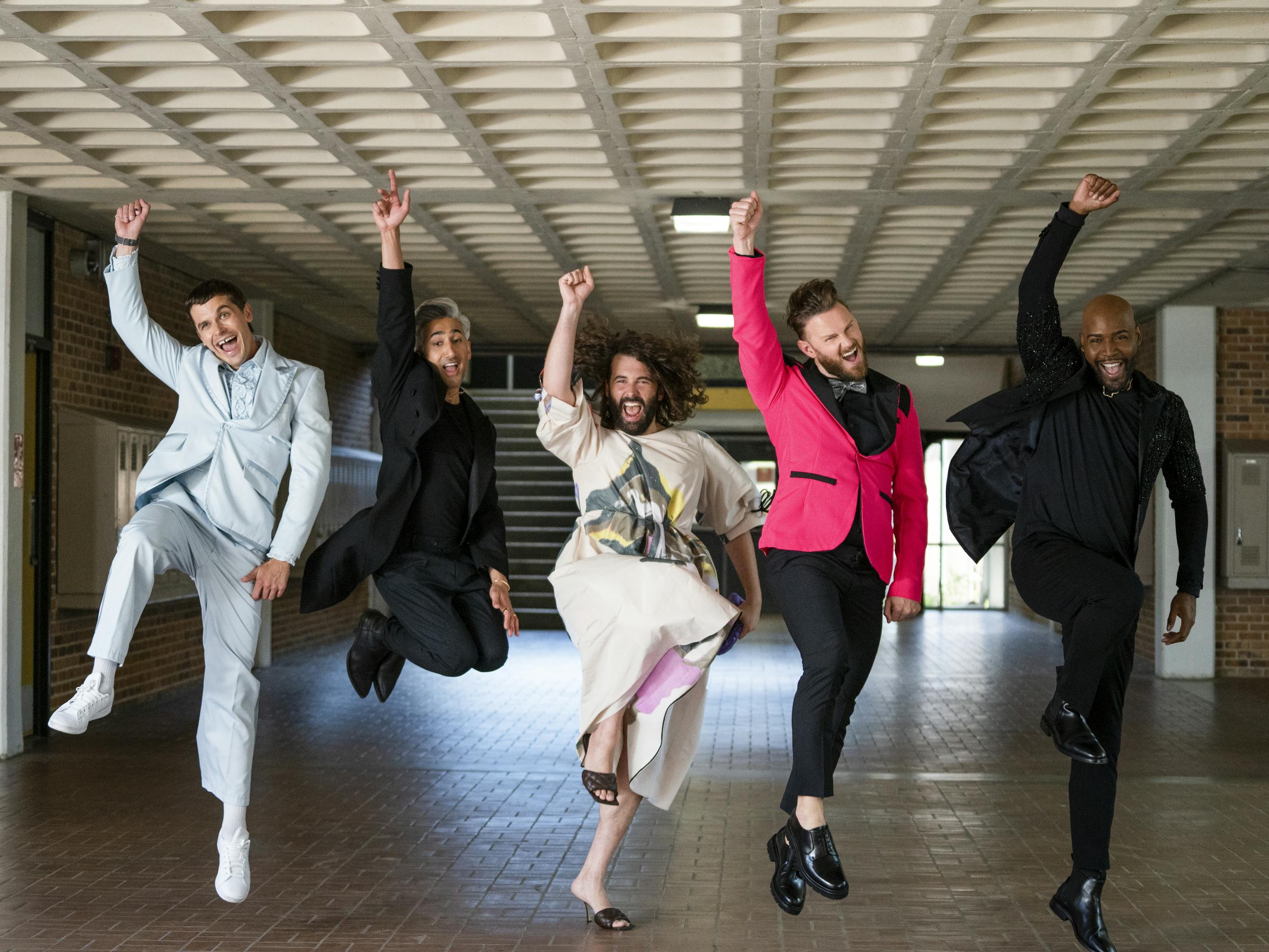 The Fab Five — Antoni Porowski, Tan France, Jonathan Van Ness, Bobby Berk, and Karamo Brown— dance in a low-ceiling room.