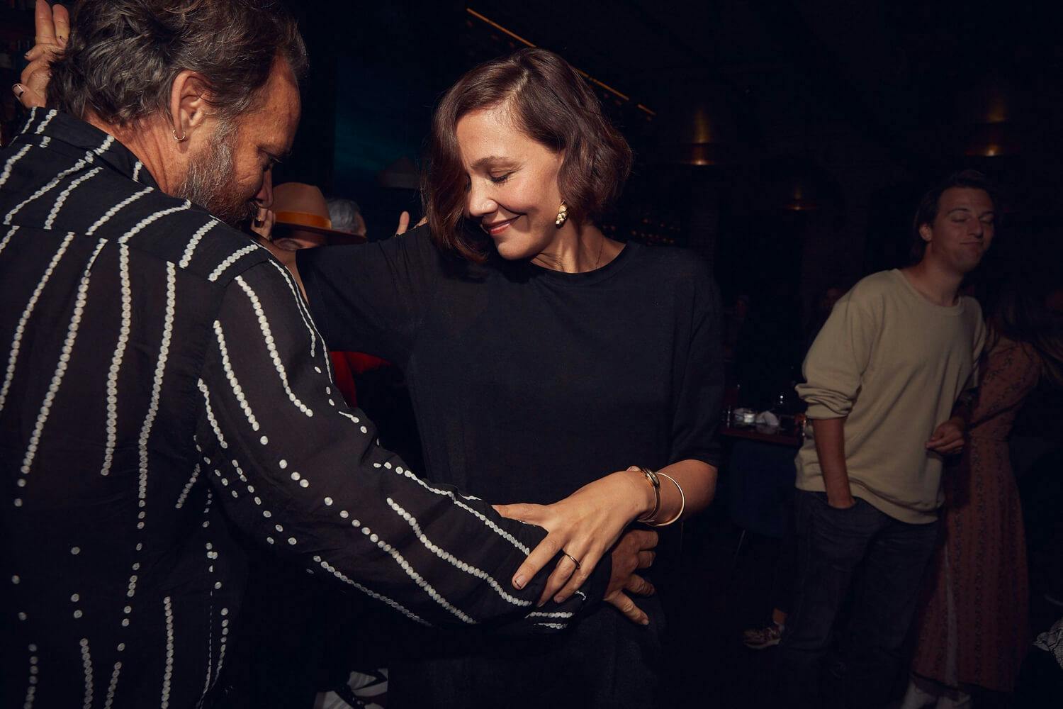 Maggie Gyllenhaal and Peter Sarsgaard dancing together at the Telluride Film Festival, 2021.