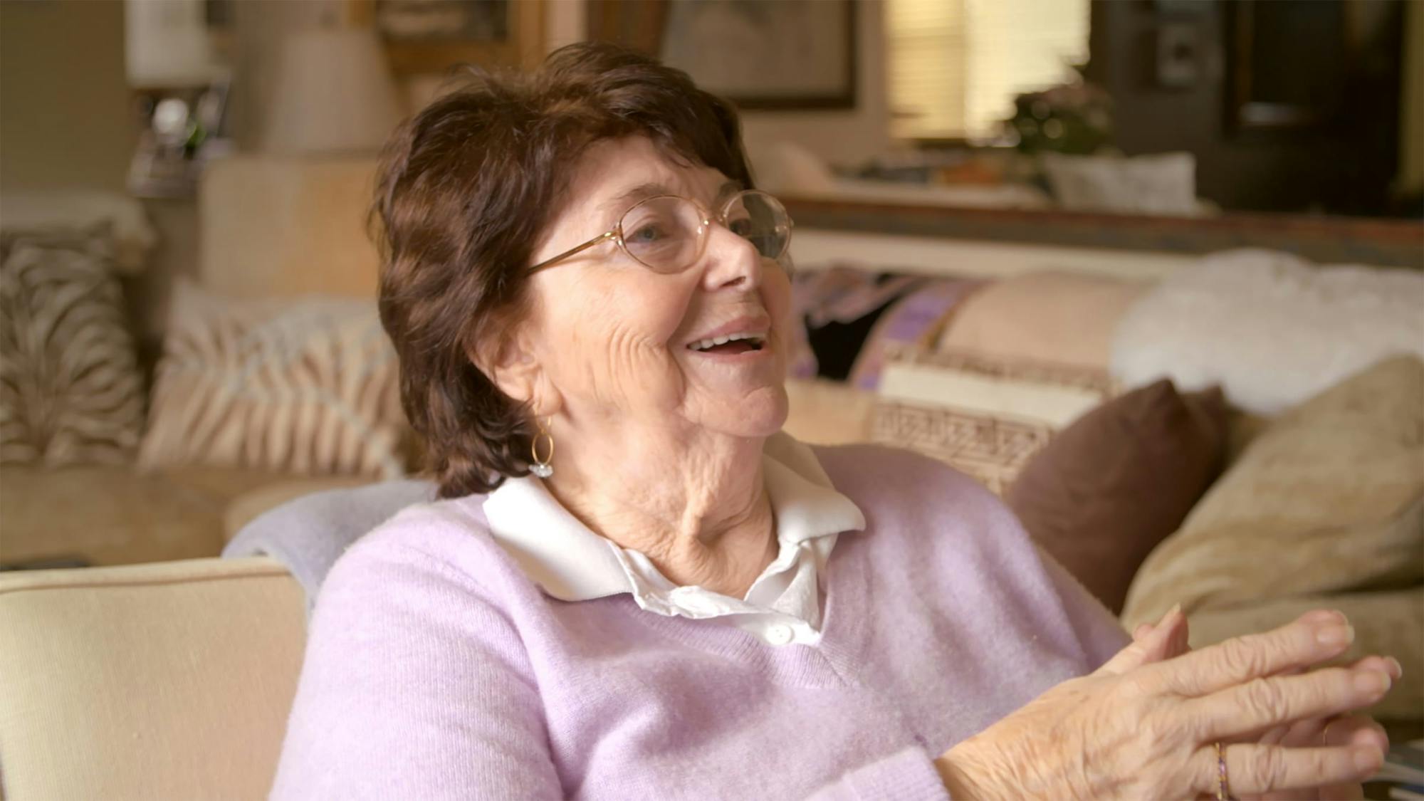 Kulik pictured in her living room, laughing. 