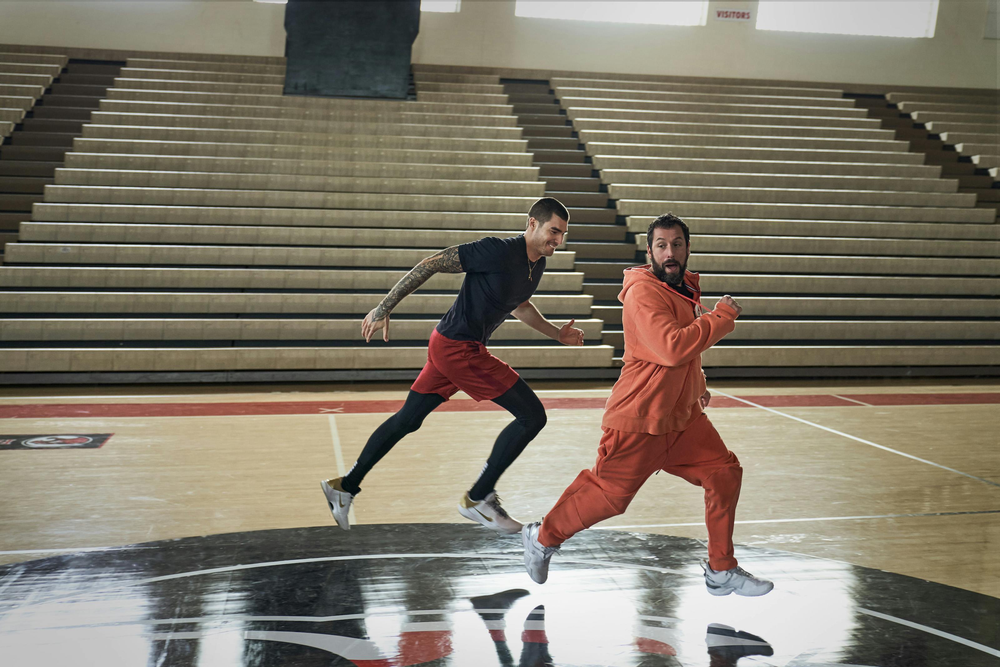 Bo Cruz (Juancho Hernangómez) and Stanley Sugarman (Adam Sandler) sprint across a court. 