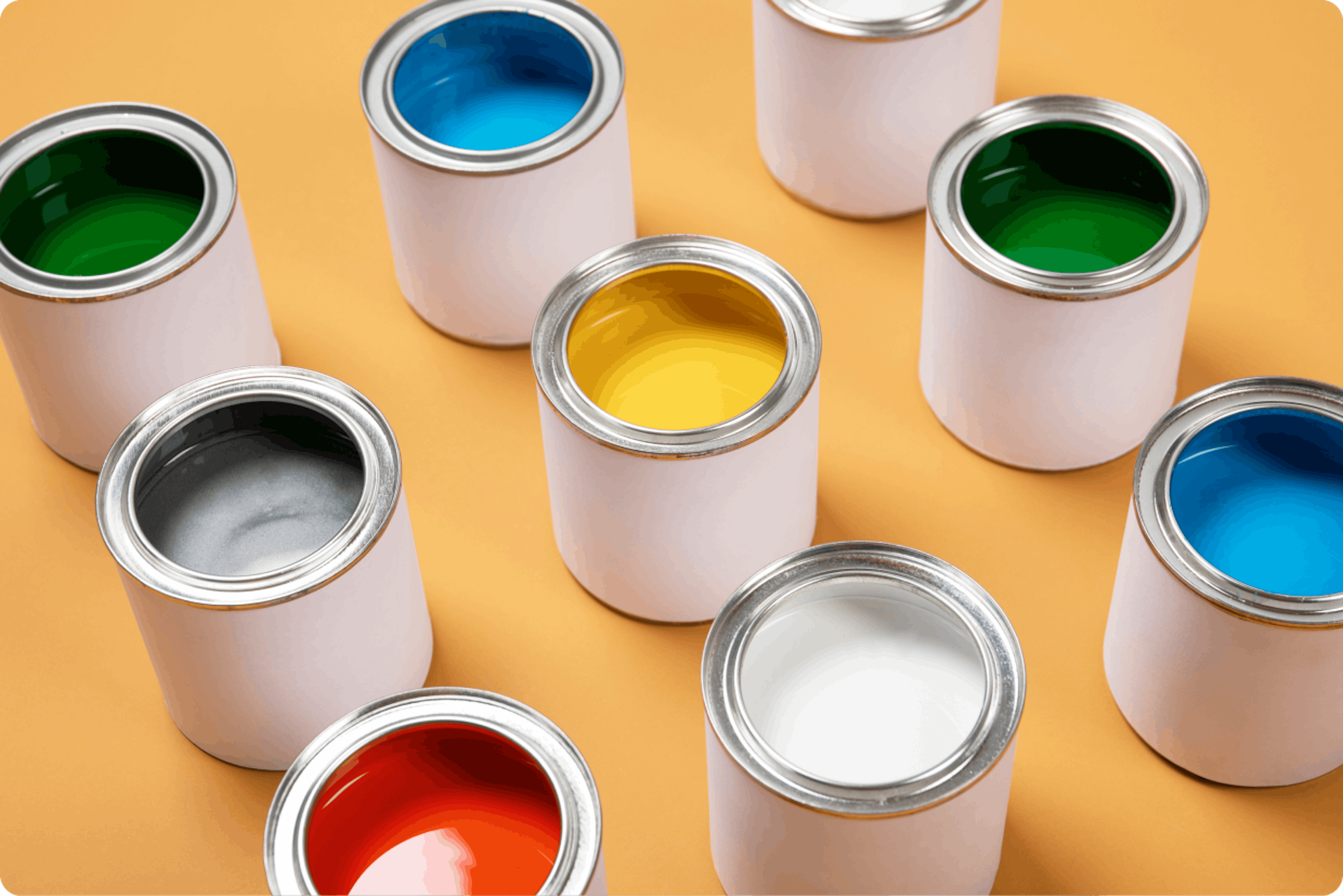 Open tins of paint on a yellow background.