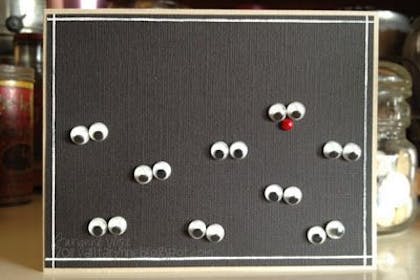 Googly eyes stuck to a piece of black card - handmade Christmas card