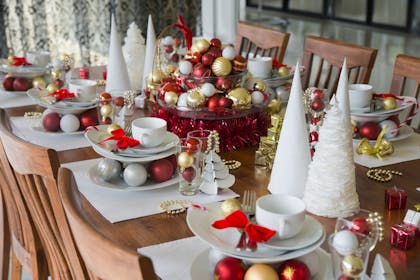 Christmas table decorated with paper cone trees and baubles