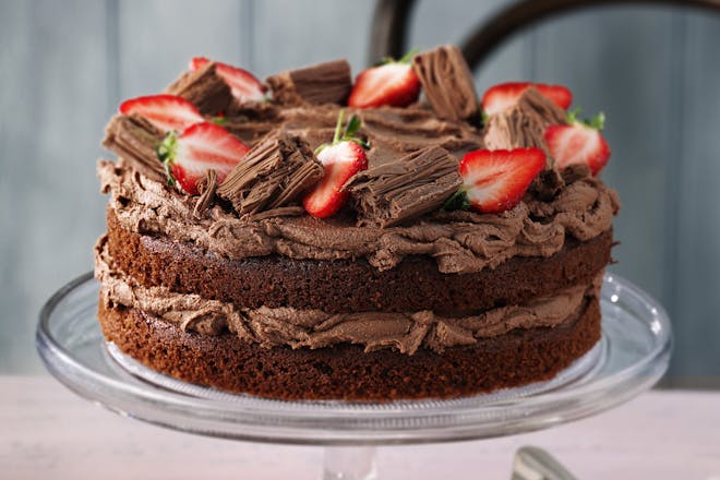 Classic chocolate cake recipe. Chocolate cake with chocolate icing and strawberries.