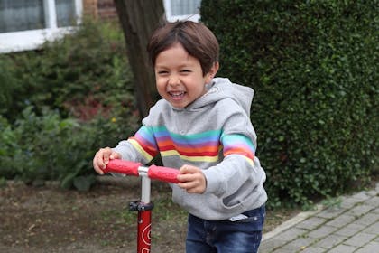 Boy riding on scooter