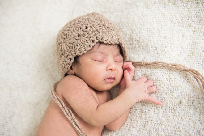 Baby boy sleeping in knitted hat