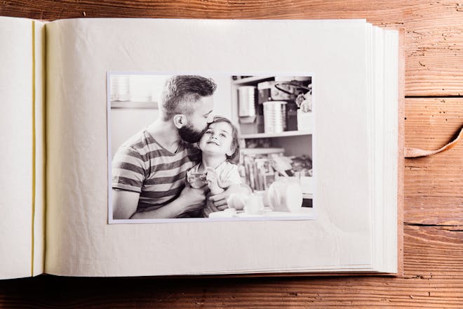 A photo album with a picture of a dad and daughter