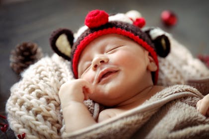 Christmas baby smiling while sleeping