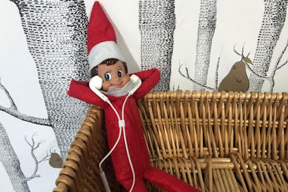 Elf on the Shelf listens to music with headphones