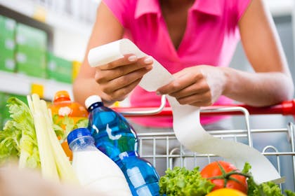 woman in supermarket with long receipt