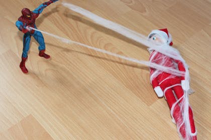 spiderman catching elf in web