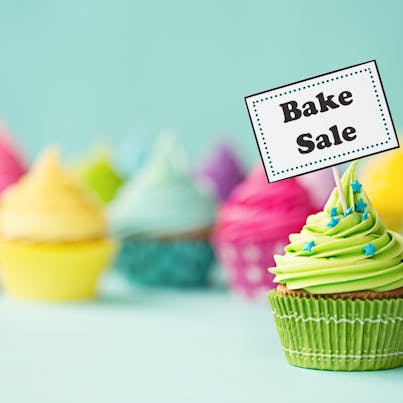 colourful cupcakes with bake sale sign 