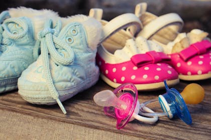 baby boy and girl shoes and dummies