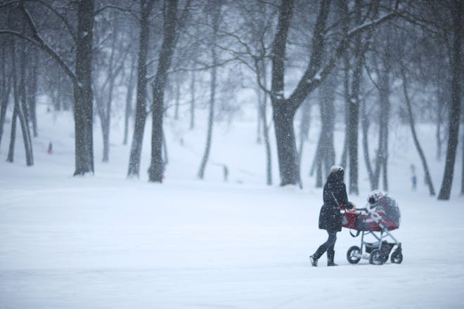 woman pushing buggy in snow