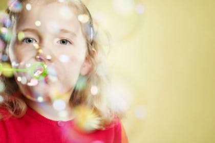 girl blowing bubbles