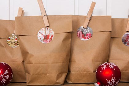 Homemade brown paper bag advent calendar fastened with pegs