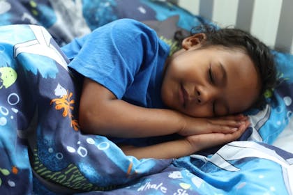 Little girl asleep in bed