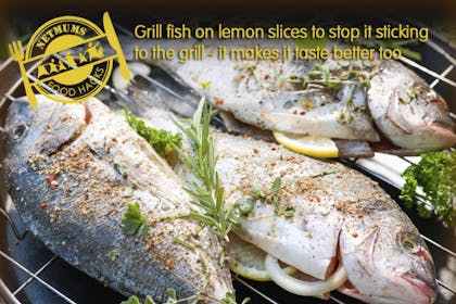 three full fish with lemon slices and herbs