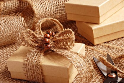 Big burlap ribbon bow on brown gift box for Christmas
