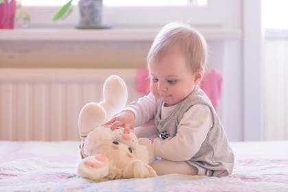 baby girl playing with toy