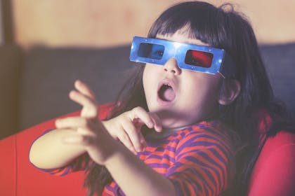 child watching a film with 3D glasses on