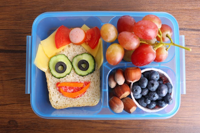 Smiley face sandwich in child's school packed lunch